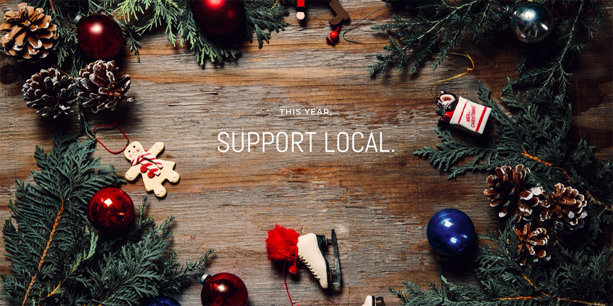 'Support Local' text surrounded by holiday decorations and pine branches