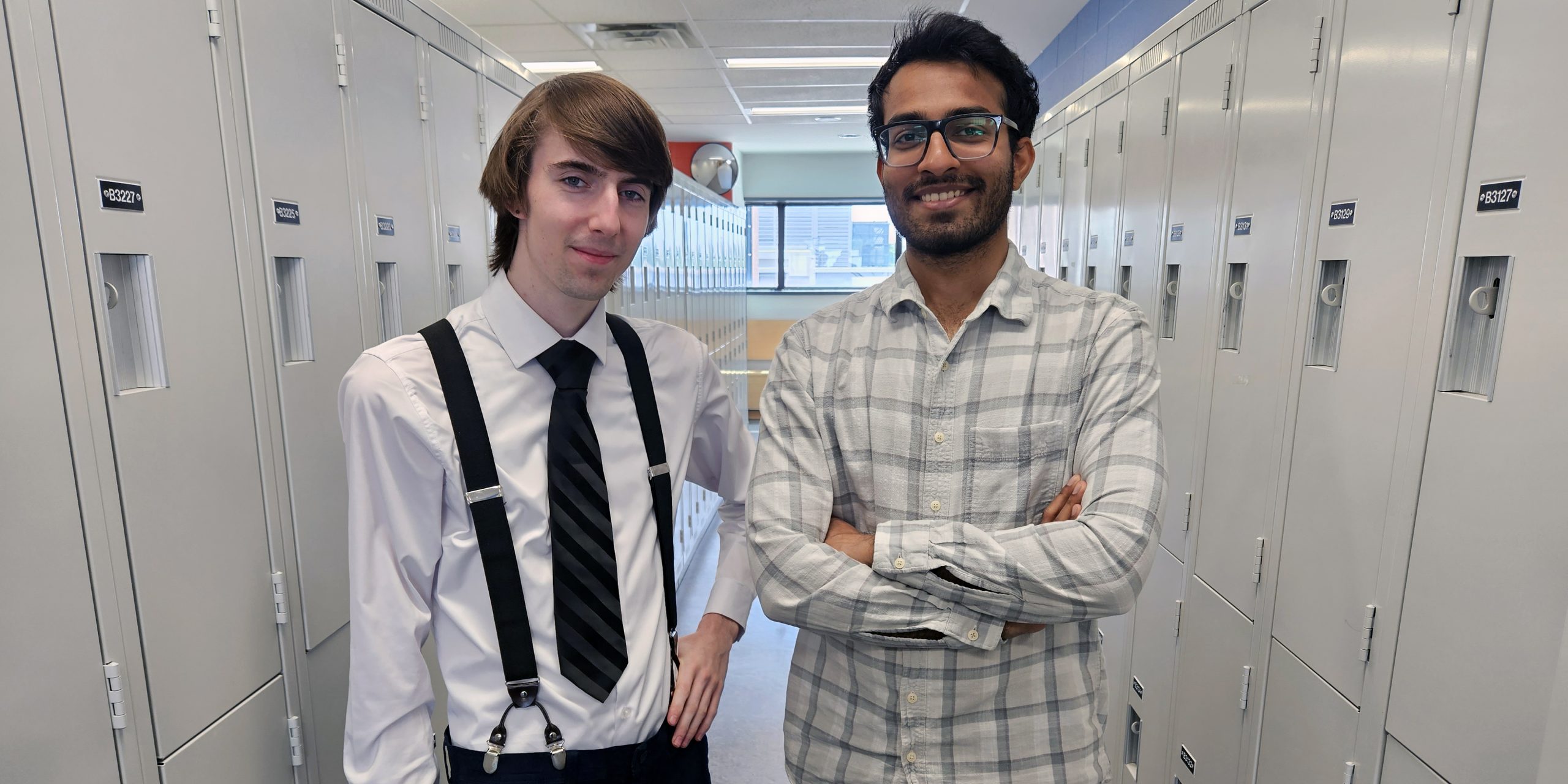 Branden Rushton and Bhavya Shah are pictured posing in front of lockers on campus at Durham College.
