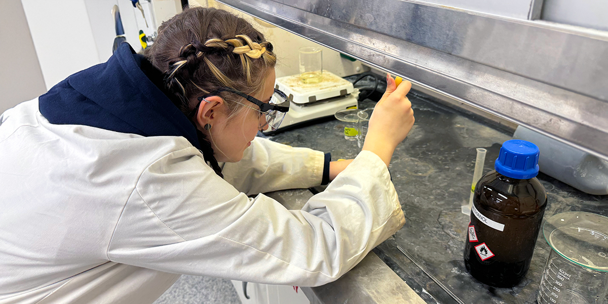 A photo of Chemical Engineering Technology student Alyssa Miniotas, working in a lab.