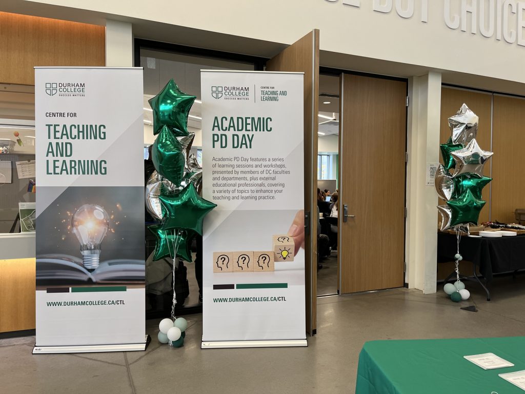 Two zap stand signs outside the Global Classroom at Durham College: Centre for Teaching and Learning and Academic PD Day.