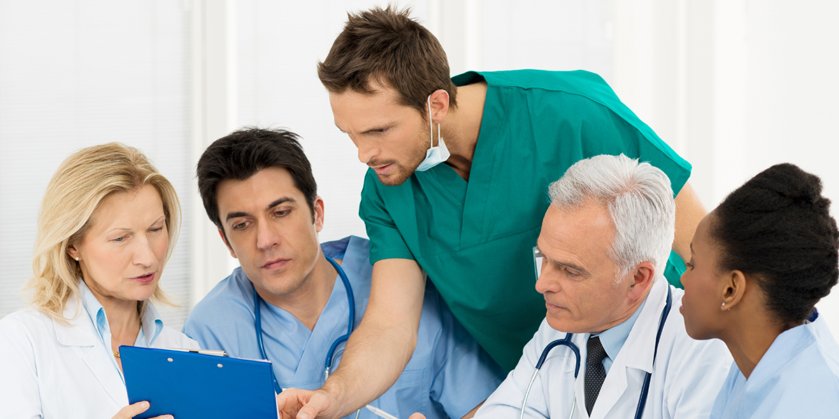 A team of medical staff reviewing a chart
