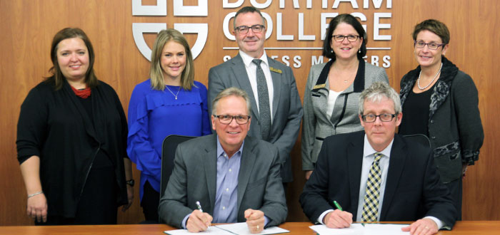 Celebrating the official signing, in the back row from left, were DC staffers: Larissa Strong, manager, international student support, Durham College International (DCI); Katie Boone, manager, international partnerships and contract training, DCI; Mark Herringer, dean, international education, DCI; Sandra Bennett, associate vice-president, Human Resources; and Elaine Popp, vice-president, Academic. Signing the agreement in the front row, from left, were: Don Lovisa, president, DC; and for Uniterra, Tom Tunney, senior manager, University and College Programming.