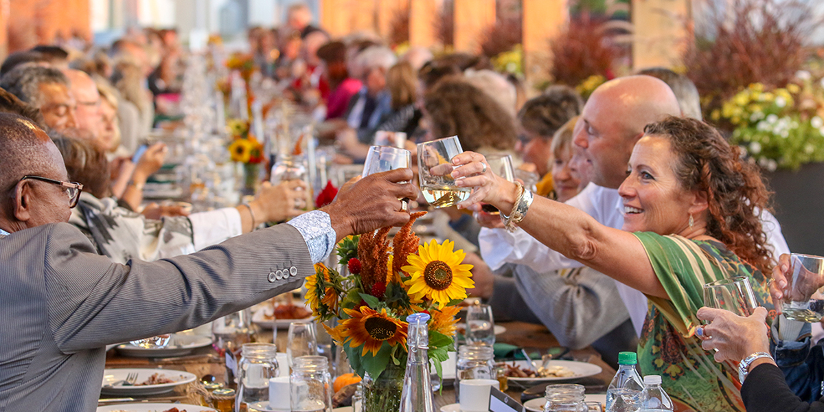 DC staff, alumni and guests make a toast at the fifth annual Harvest Dinner