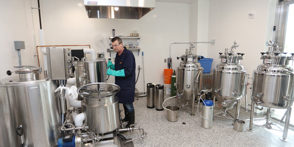 Student using brewery equipment at DC's brew lab