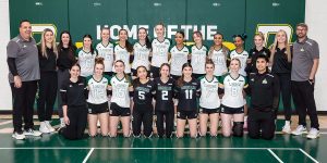 The women's volleyball team lines up for a photo.