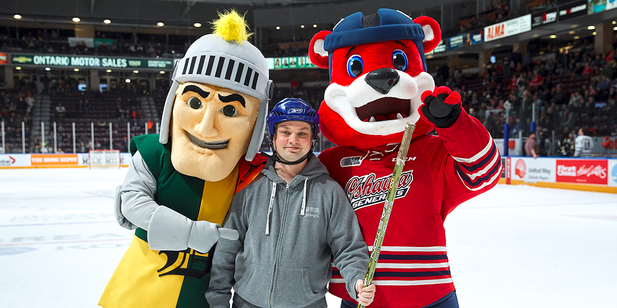 Fan posing with Durham Lords and Oshawa Generals mascots
