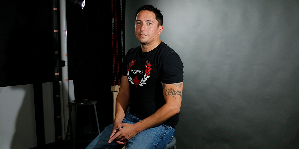 Chris Cull sitting on a stool during the video shoot for the filming of the Surviving Addiction docuseries
