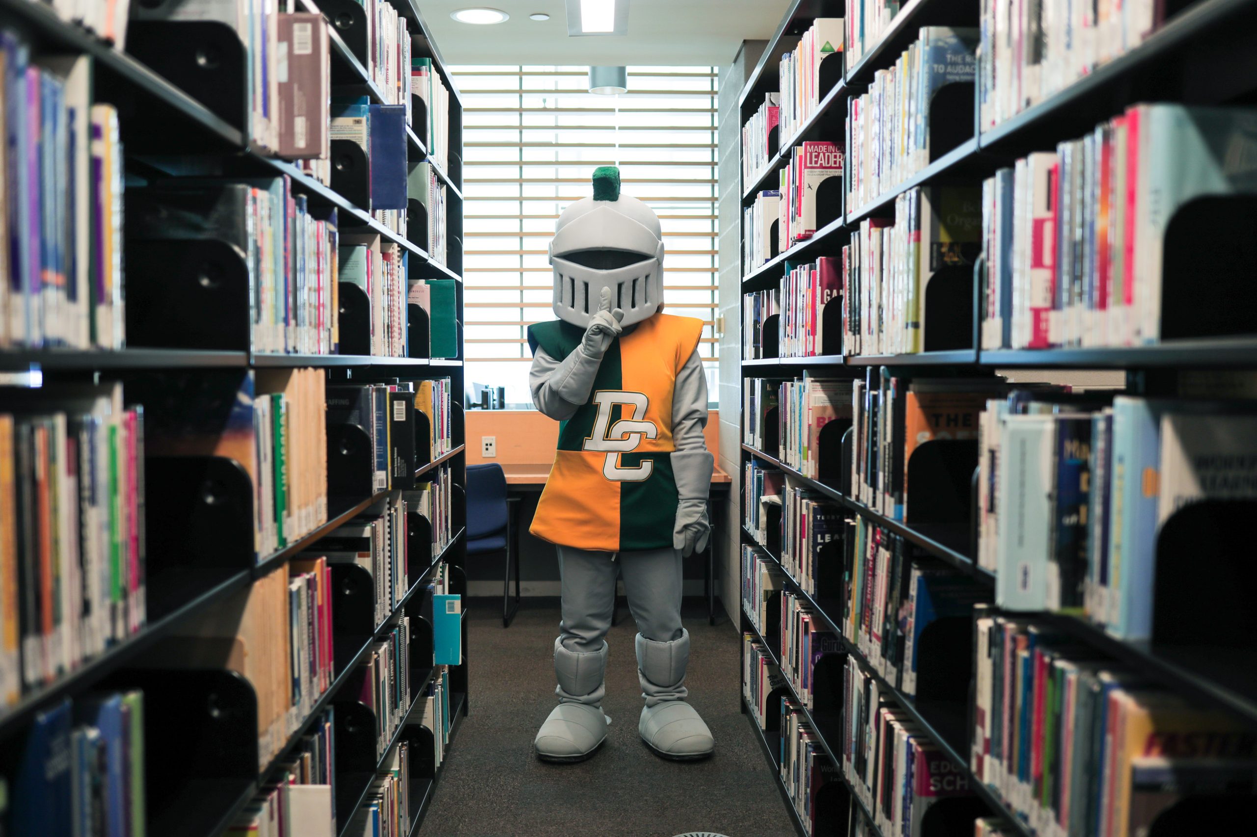 lou the lord mascot is in the library, shushing