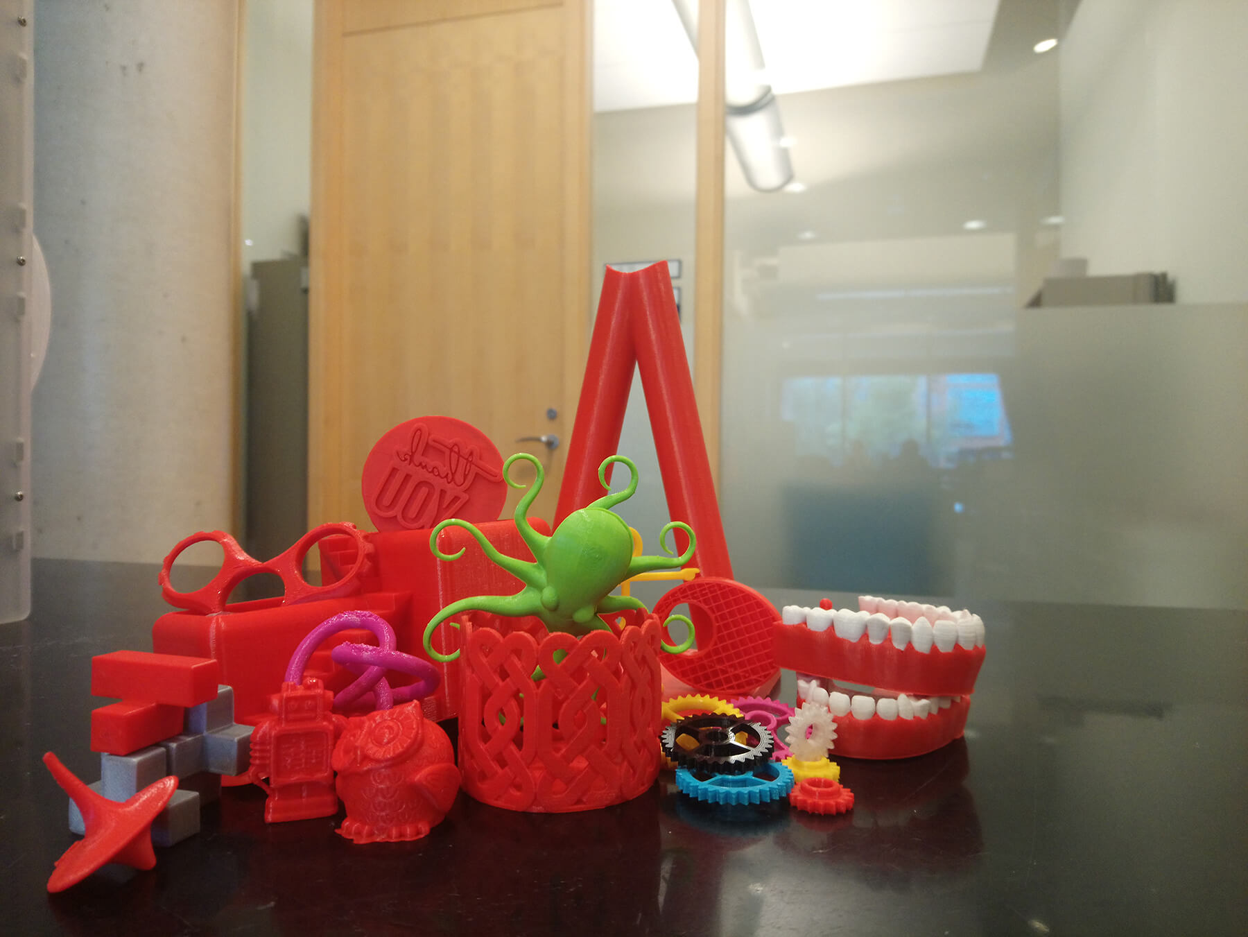 A variety of 3D printed items in various colours