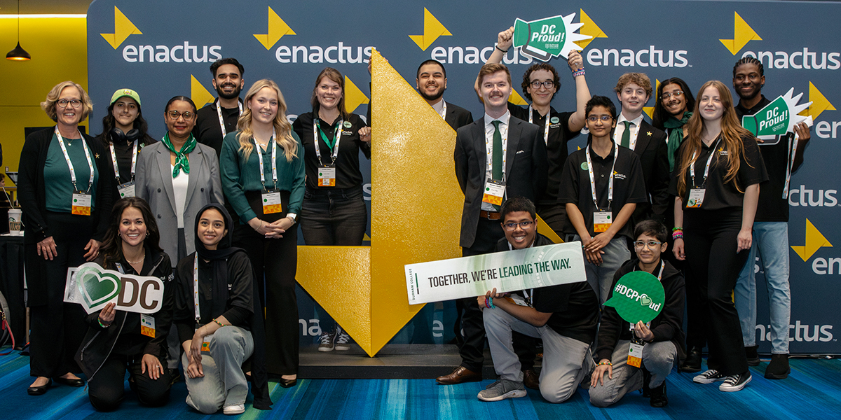 The Enactus team faces the camera and smiles.