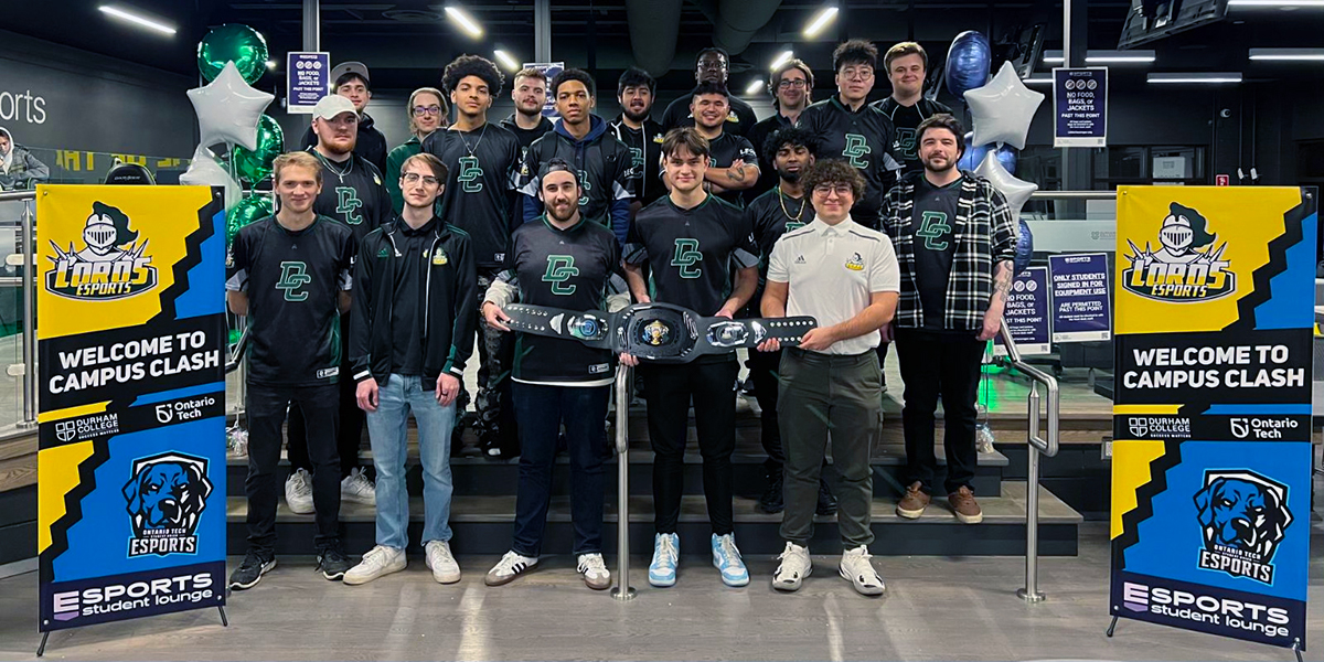 The members of DC's Esports team line up and smile at the camera.