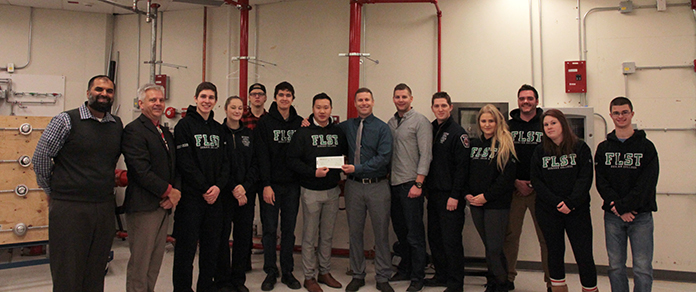 Camp Bucko recieving the cheque from students in the Fire and Life Safety Systems programs and Pre-service Fire Fighting program. (From left to right) Randy Panesar, Ralph Hoffman (Associate Dean at the School of Justice and Emergency Services), Mark Pitropov (Vice-President), Jessica Tyson, Dylan Biro, Daniel Gunda, Edward Chan (President), Steve Heidinga, Bryan Stong (Camp Bucko Board of Directors members), Andrew Will, Alycia Olesky (Vice-President), Kevin Ritz (President), Terri Gill, Derek Sailsbury.