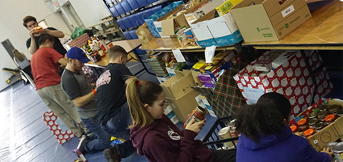 Volunteers filling food hampers at DC's annual holiday food drive