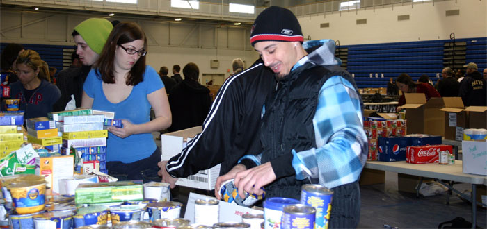 Volunteers pack boxes at the Holiday Food Drive
