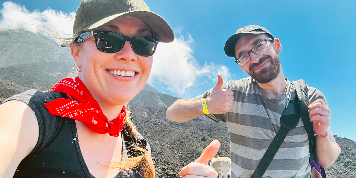 DC professor Jennifer Friedman and video production student Shane Friedman are pictured outdoors in Guatemala giving a thumbs up.