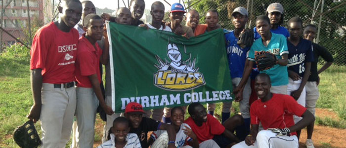 Ugandan youths holding Durham Lords flag