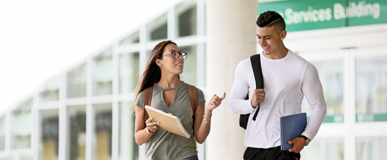 Two students walking on campus