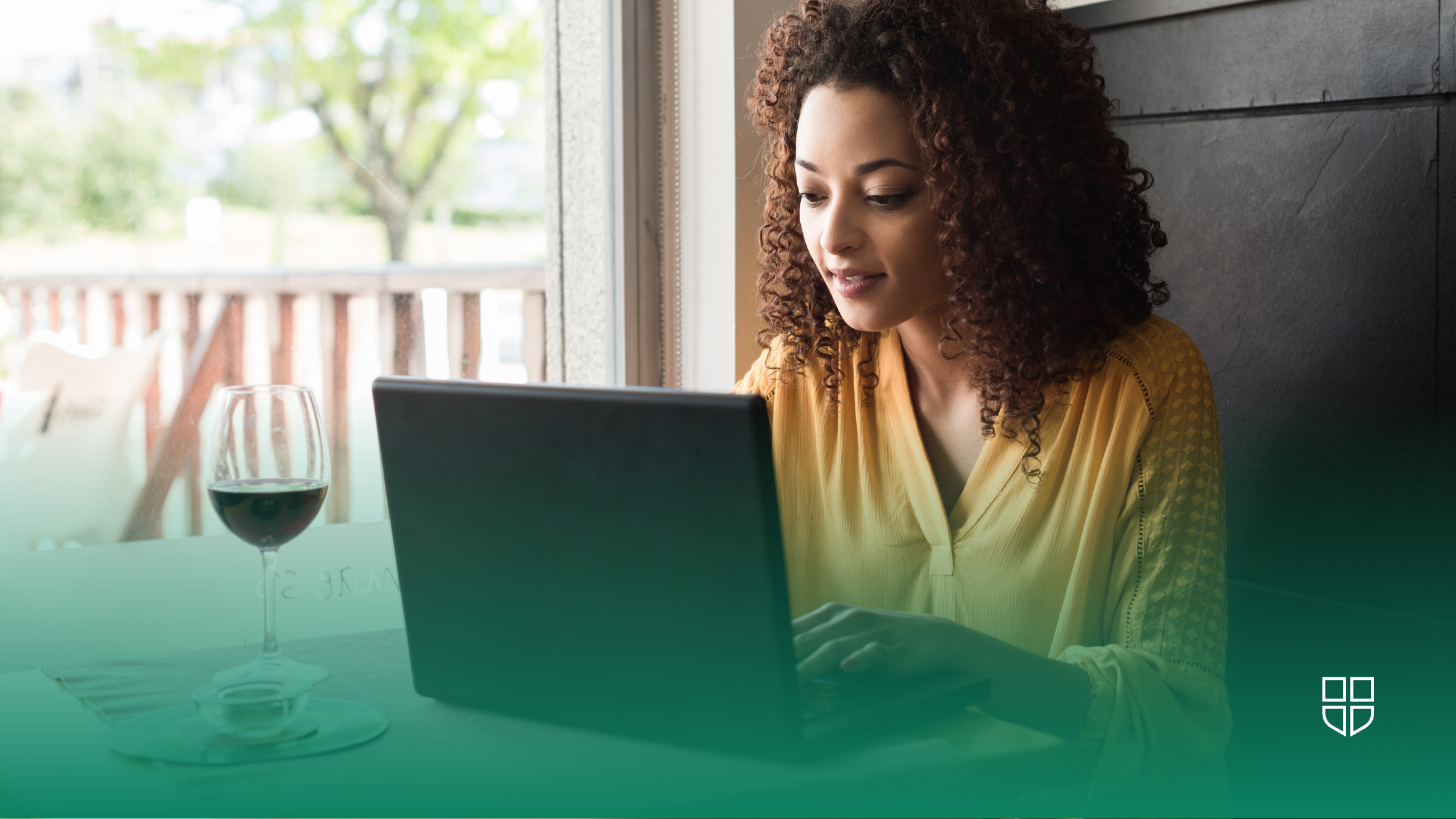 A student sitting in their living room with a laptop on their lap.