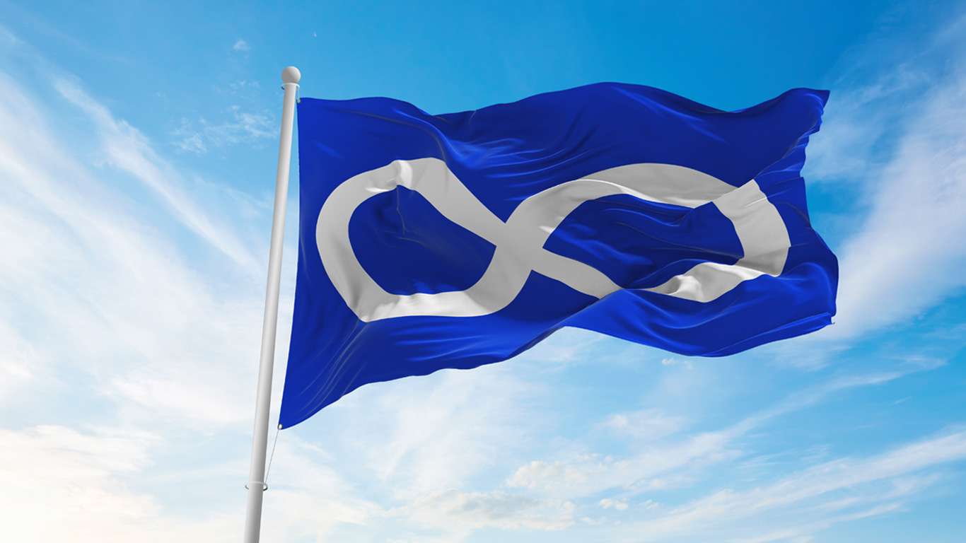 A blue and white Métis flag flaps in the wind