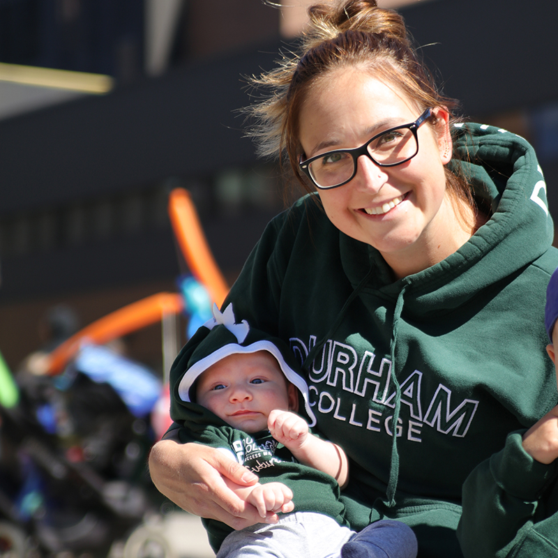 Student and Child wearing Durham College Apparel