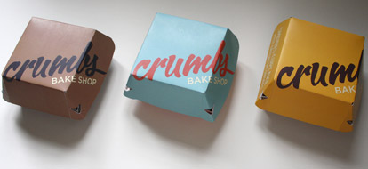 A mock-up of packaging for a fictional cupcake line called Crumbs