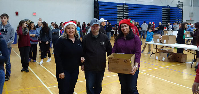 Alumni Association board president and members lend a helping hand packing hampers.