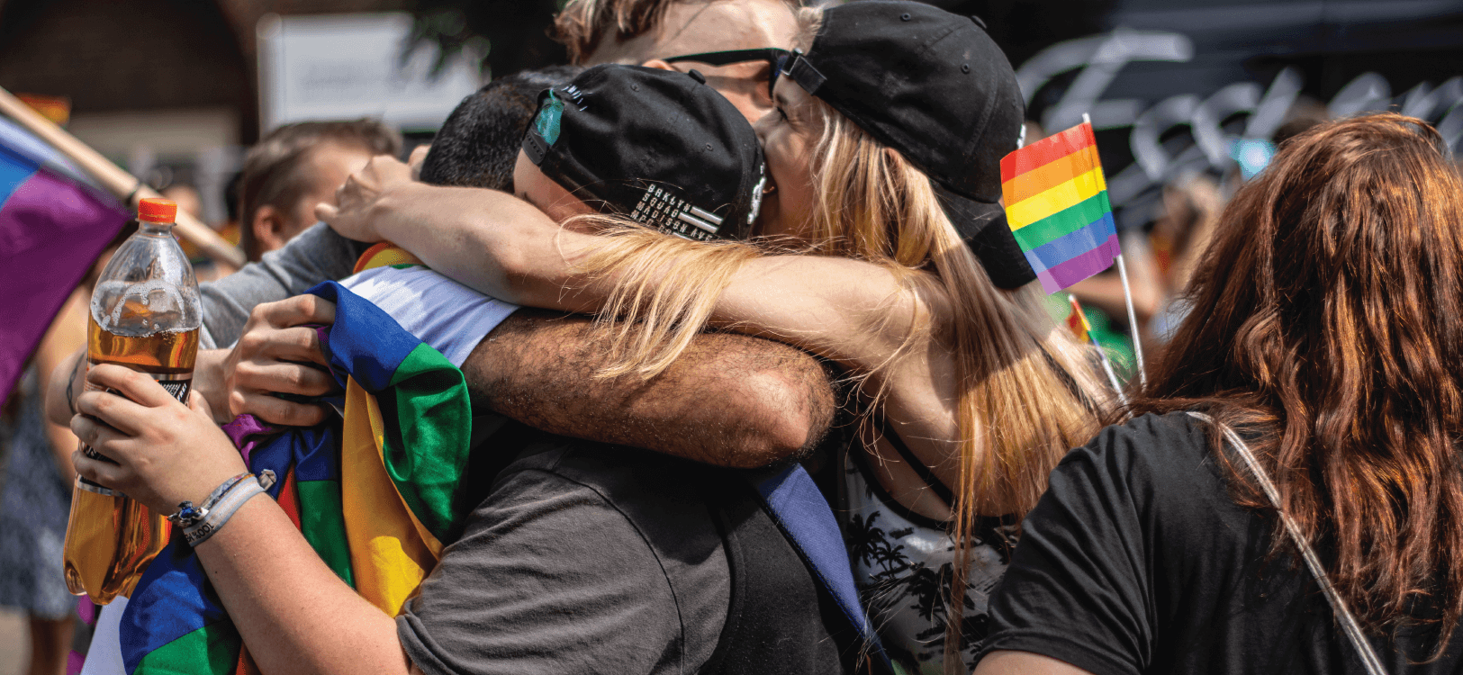 image of people hugging at pride parade