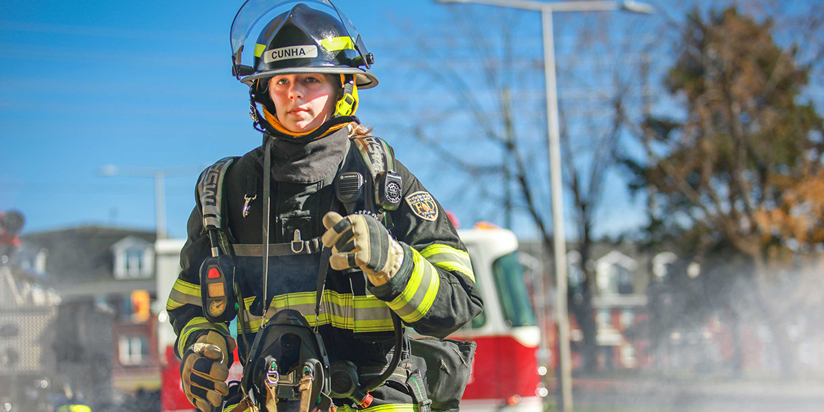 A firefighting student completes a training exercise.