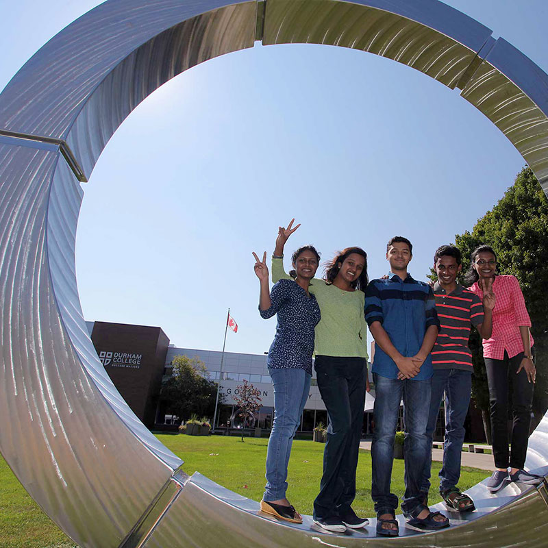 International students standing inside the Durham College Stargate