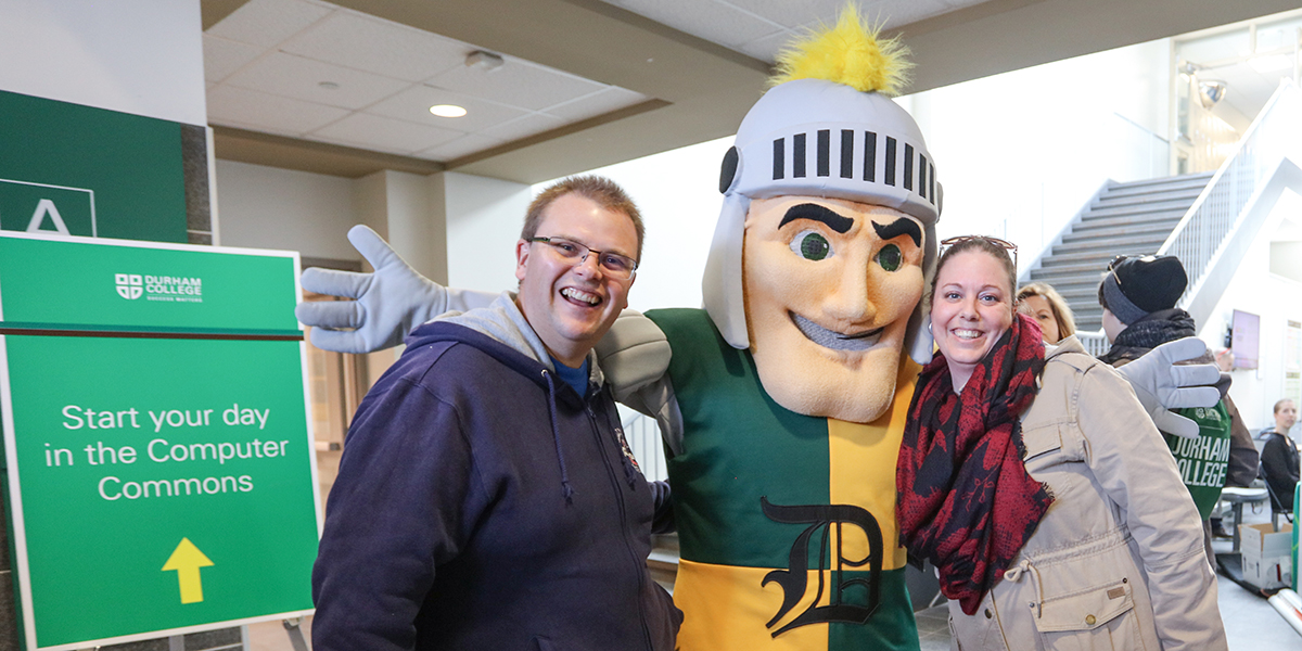DC Oshawa campus open house, prospective students posing with school mascot Louis the Lord
