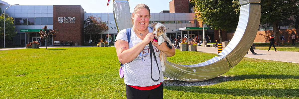 DC student Linzie Mark with her service dog on campus