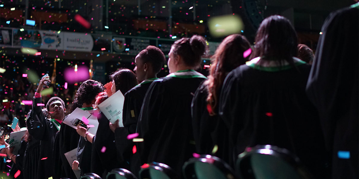 Students celebrate on day 3 of convocation, with confetti in the air