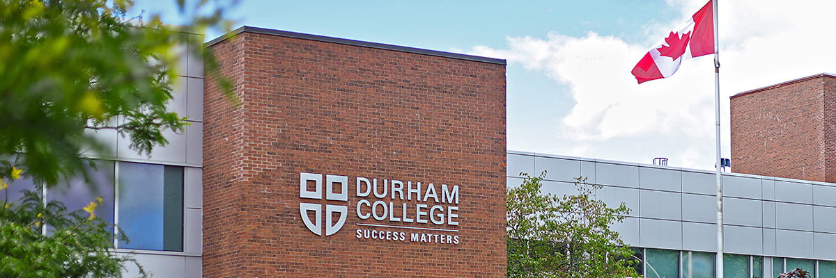 DC logo in view on the Gordon Willey building at Durham College.