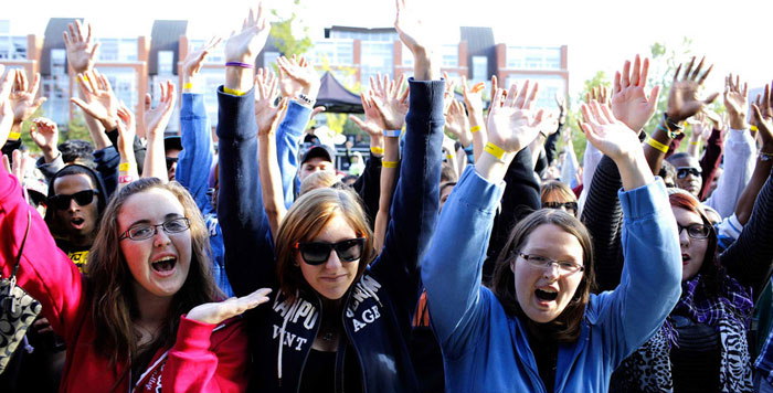 Durham College students raising their hands