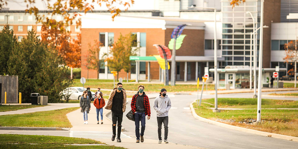 Durham College students walking through the Gordon Wiley building
